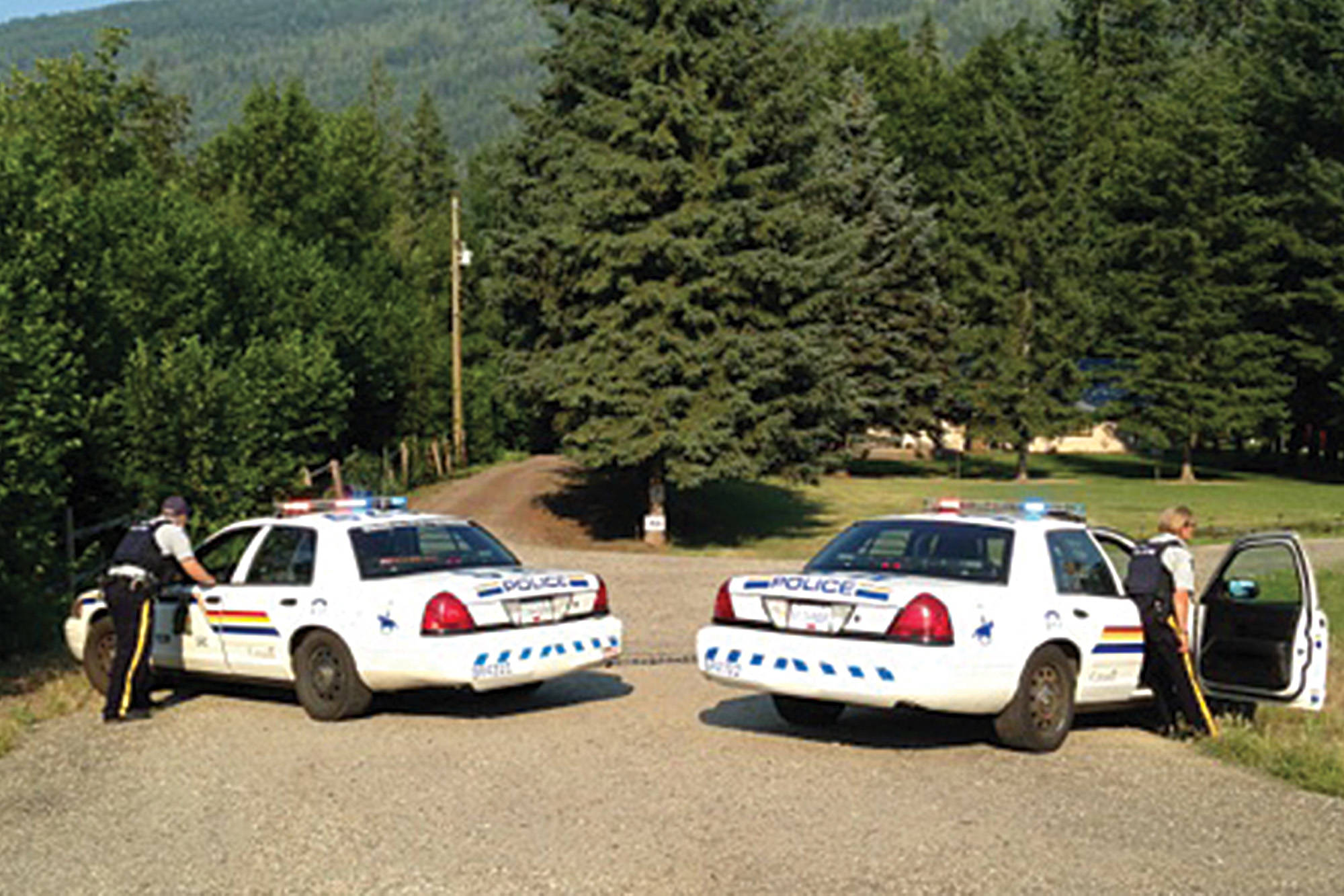 RCMP block the driveway of a Canoe property where a suspect in an armed robbery in Sicamous on July 3, 2015 is alleged to have driven into after fleeing police. (File photo)