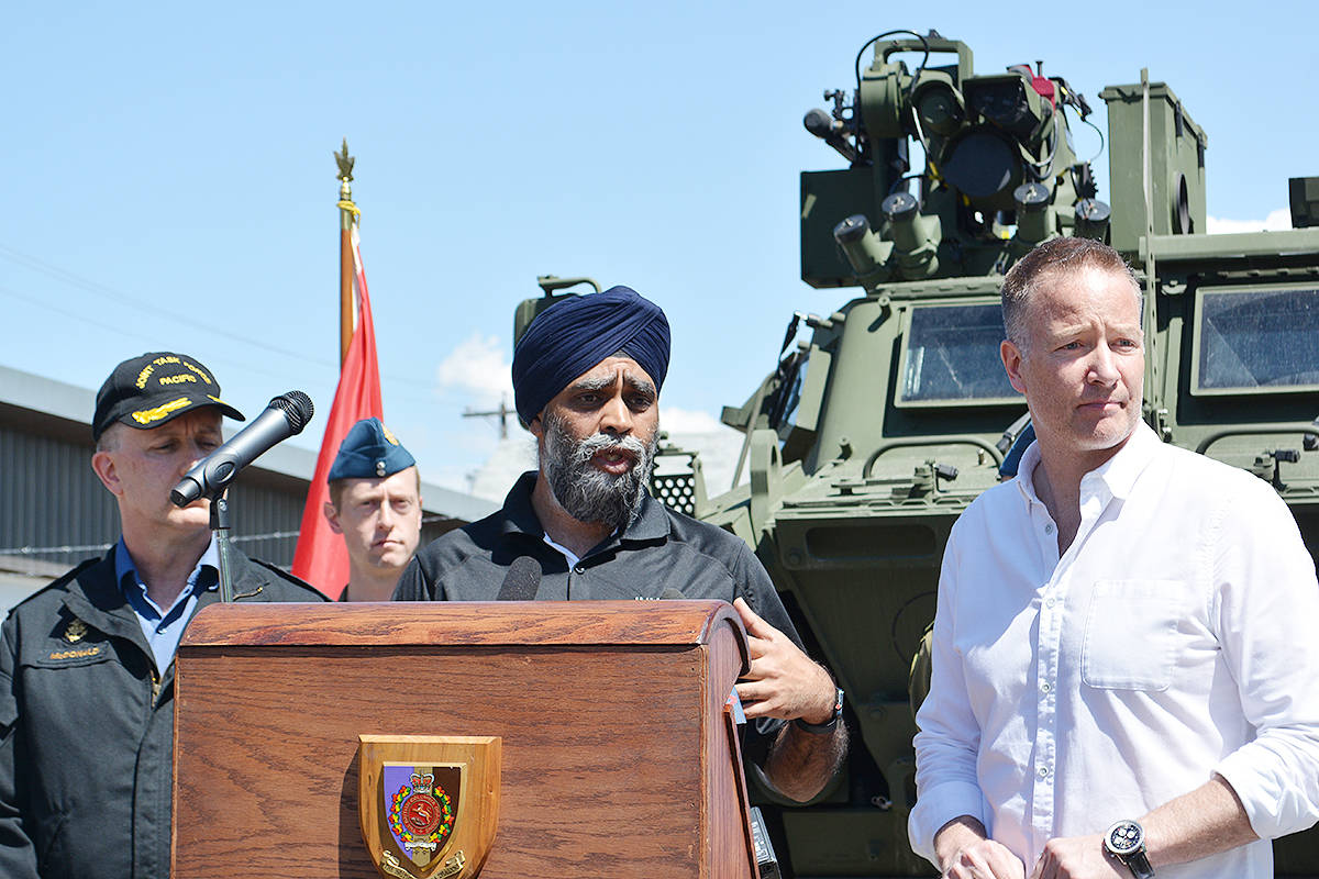 Defence Minister Harjit Sajjan, speaking to the media in Kelowna Monday flanked by Admiral Art McDonald of the Canadian Navy, commander of Joint Task Force Pacific (left) and Kelowna-Lake Country MP Stephen Fuhr. —Image: Alistair Waters/Capital News