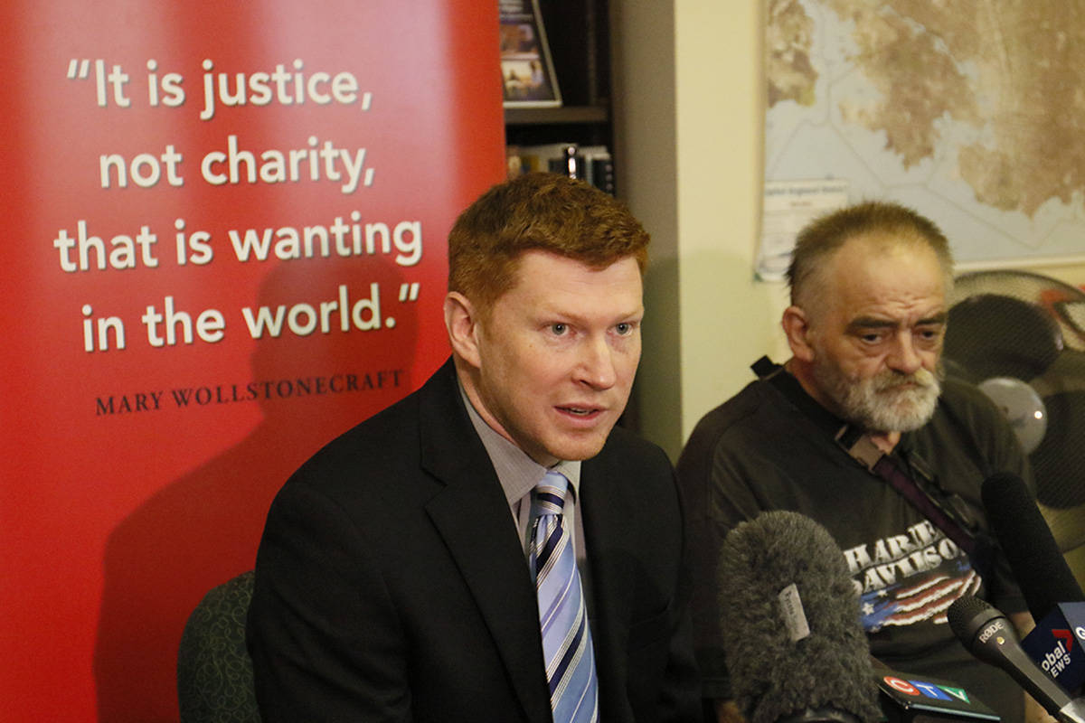 Doug King (left), lawyer and executive director of TAPS, addresses the media with Doug Swait (right), a resident of 844 Johnson St. and one of the lead plaintiffs in the case against the Portland Hotel Society restricting the rights of tenants at the building managed by the non-profit housing provider. Kristyn Anthony/VICTORIA NEWS