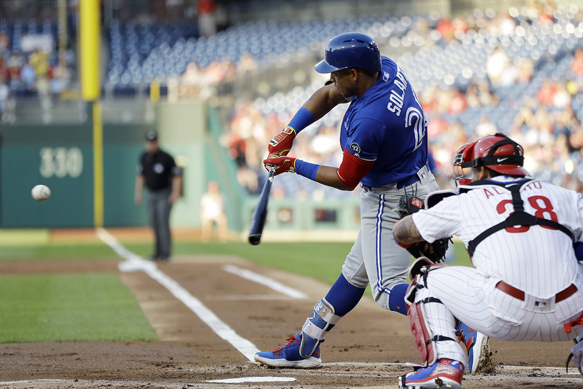 Toronto Blue Jays’ Yangervis Solarte, front left, hits a run-scoring double off Philadelphia Phillies starting pitcher Zach Eflin during the first inning of a baseball game, Friday, May 25, 2018, in Philadelphia. Phillies catcher Jorge Alfaro, right, looks on. (AP Photo/Matt Slocum)