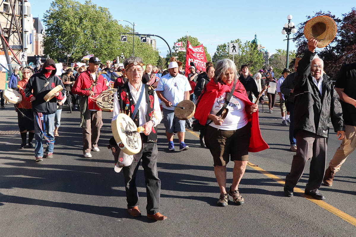 Local and visiting Indigenous marchers sing and drum in leading a protest parade Thursday evening along Wharf Street, opposing the Kinder Morgan pipeline buyout by the federal government. After a series of speeches in front of the Visitor’s Information Centre, hundreds of marchers made their way to Centennial Square, where they met many more participants. Don Descoteau/Victoria News