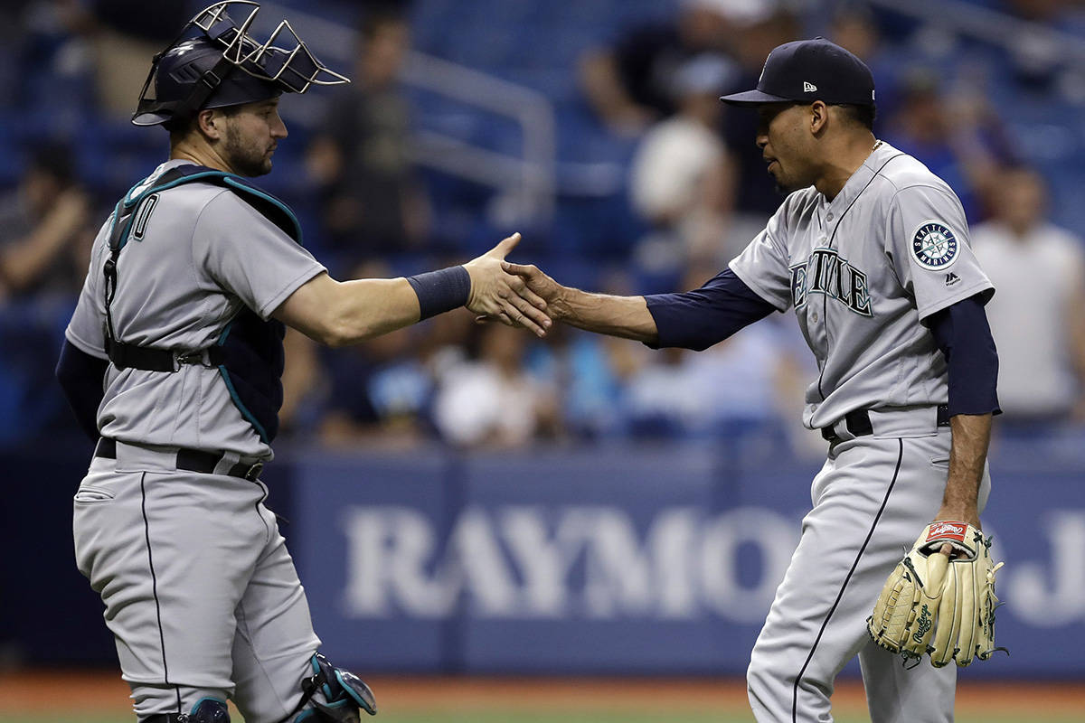 Seattle Mariners relief pitcher Edwin Diaz, right, shakes hands with catcher Mike Zunino after closing out the Tampa Bay Rays during the ninth inning of a baseball game Friday, June 8, 2018, in St. Petersburg, Fla. The Mariners won the game 4-3. (AP Photo/Chris O’Meara)