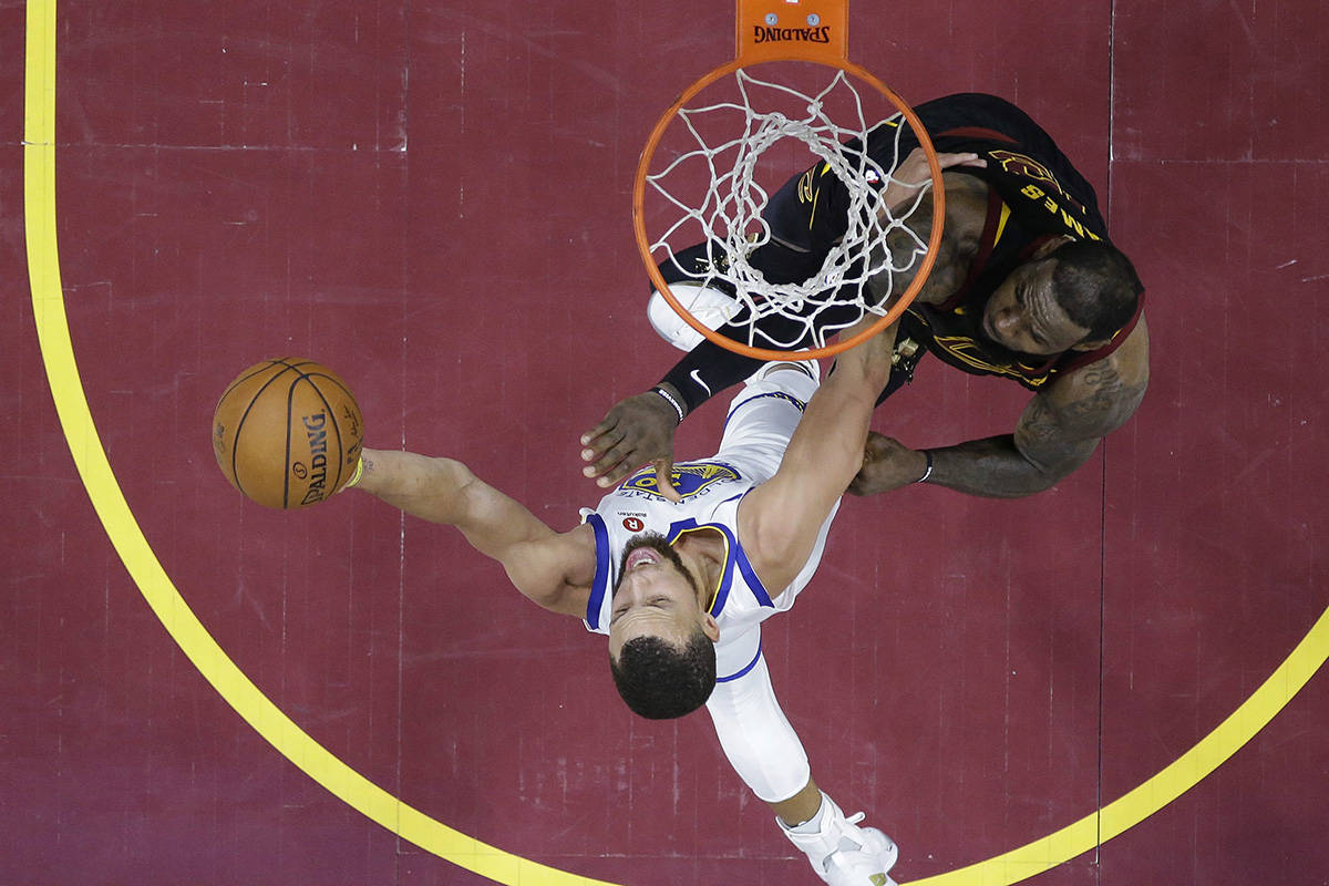 Golden State Warriors’ Stephen Curry shoots against Cleveland Cavaliers’ LeBron James during the second half of Game 4 of basketball’s NBA Finals, Friday, June 8, 2018, in Cleveland. (AP Photo/Carlos Osorio, Pool)