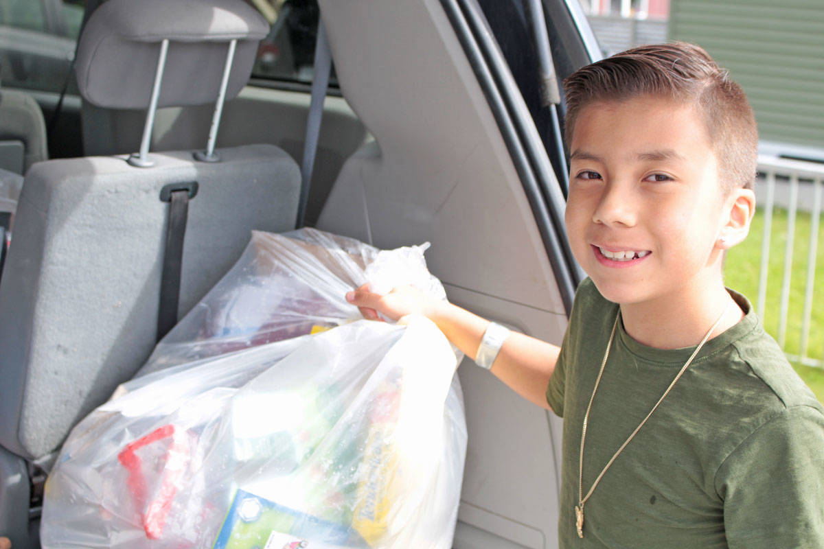 Nine-year-old Alexander Fast is cleaning up the world, one trip to the recycling depot at a time. (Keili Bartlett / The Northern View)
