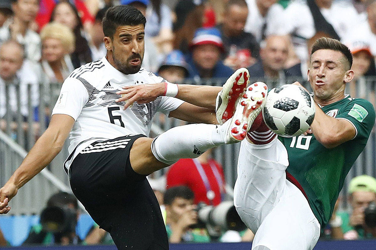 Germany’s Sami Khedira, left, and Mexico’s Hector Herrera challenge for the ball during the group F match between Germany and Mexico at the 2018 soccer World Cup in the Luzhniki Stadium in Moscow, Russia, Sunday, June 17, 2018. (AP Photo/Matthias Schrader)