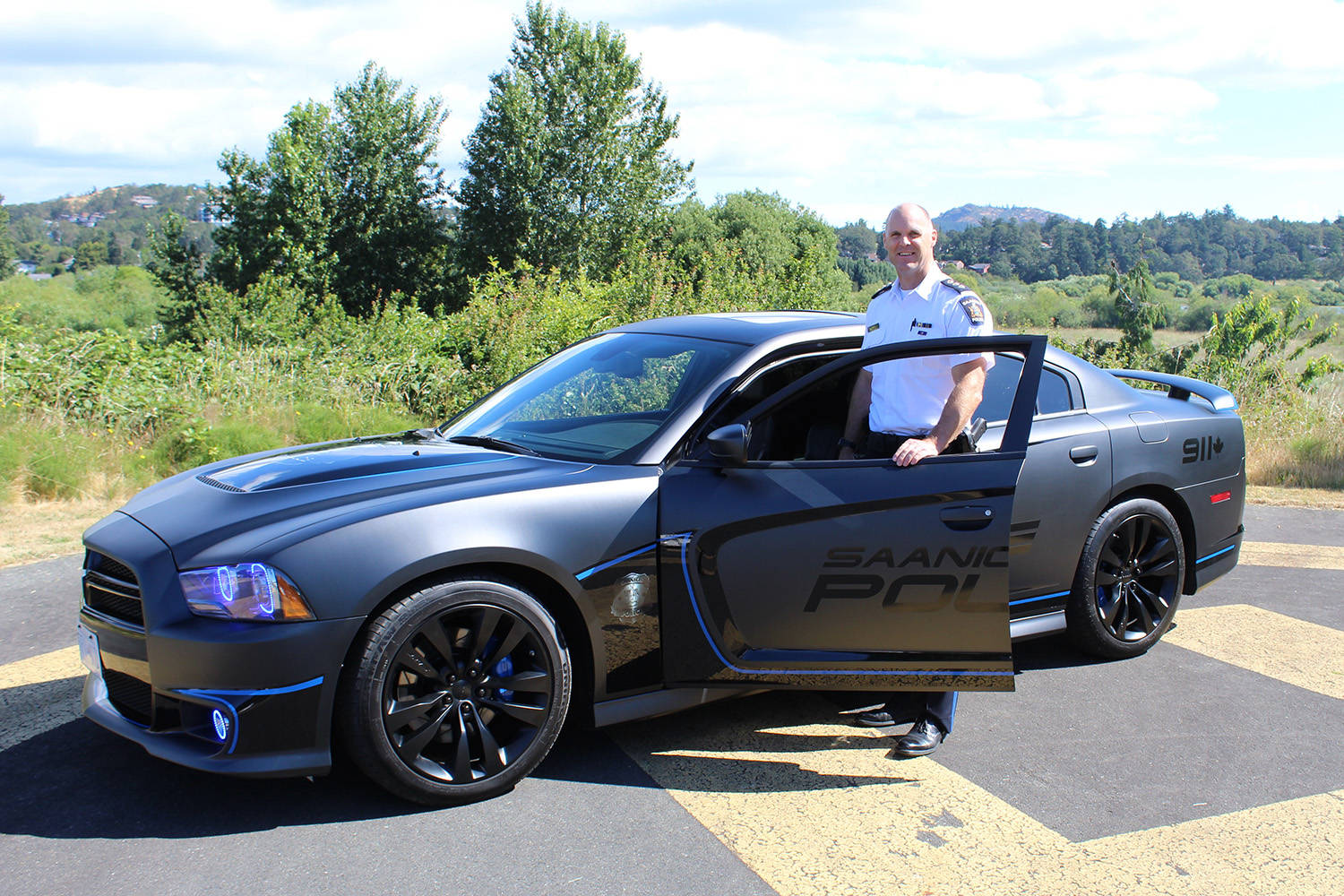 Insp. Trent Edwards of Saanich Police’s Community Engagement Division shows off the forfeited 2012 Dodge Charger SRT-8 that will serve as the new community engagement vehicle. Wolf Depner/News Staff