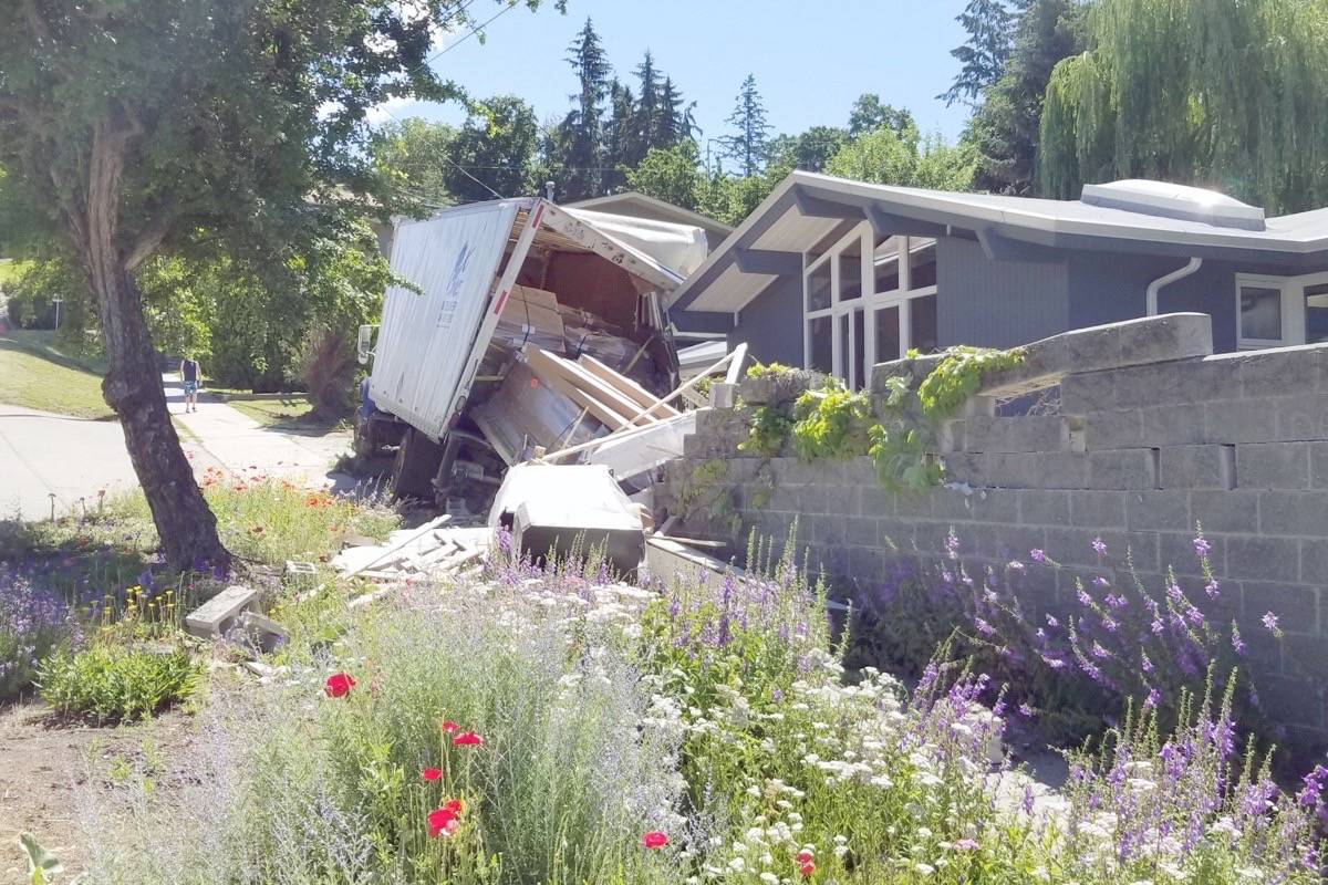 A delivery truck stalled and rolled down a hill an into this Vernon house Wednesday, July 4, 2018. (Roger Knox/Vernon Morning Star)