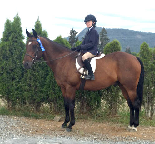 Heidi Stotmann and Champ pose with their blue ribbon, earned at the horse show during the BC 4H Okanagan Stock Show last weekend in Armstrong. (Submitted Photo)