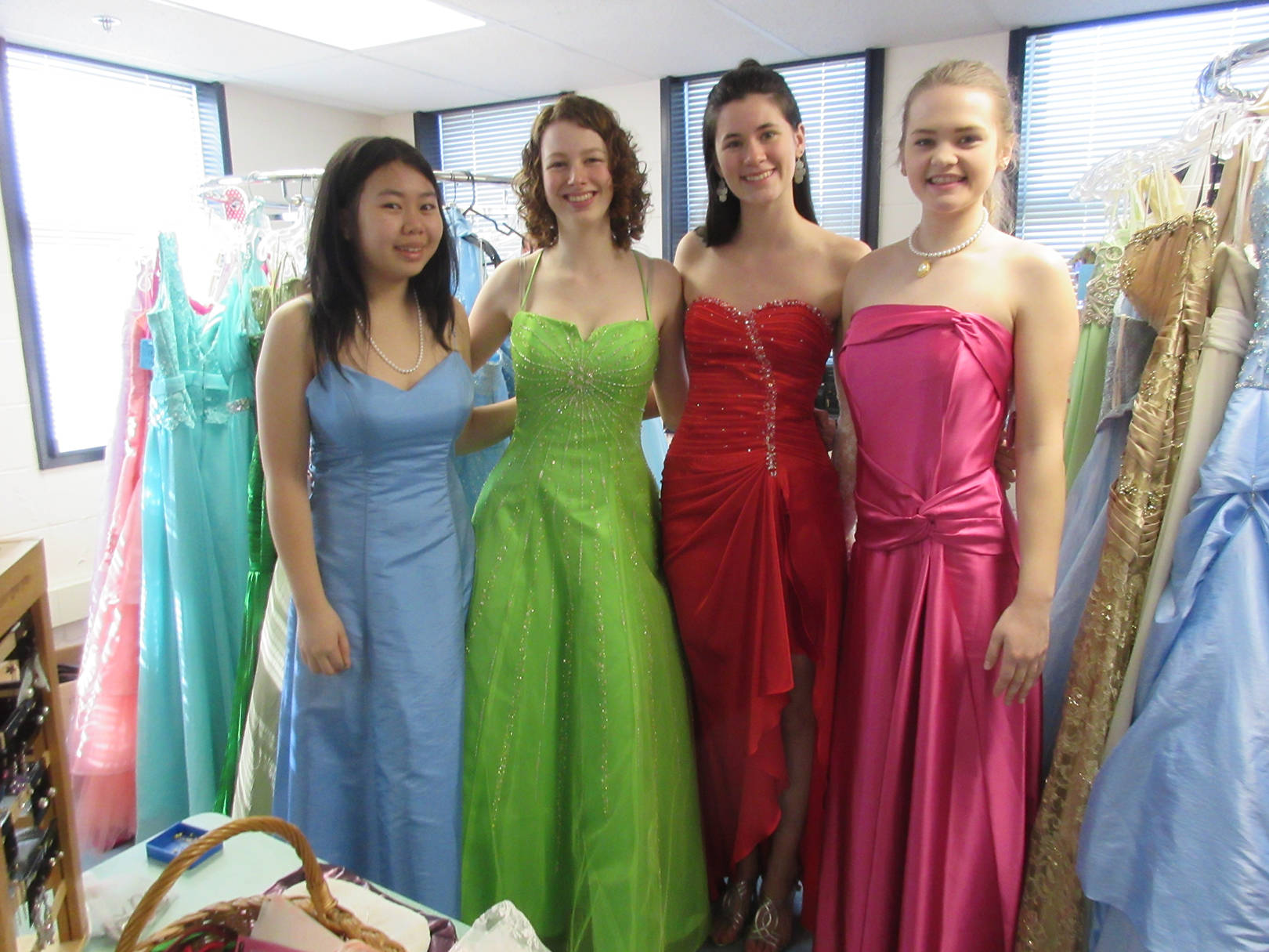 Four young women prepare to model Magic Wand dresses at a recentfashion show. Magic Wand, which provides grad dresses and tuxedos for students, is now in need of a new home. (Photo submitted )
