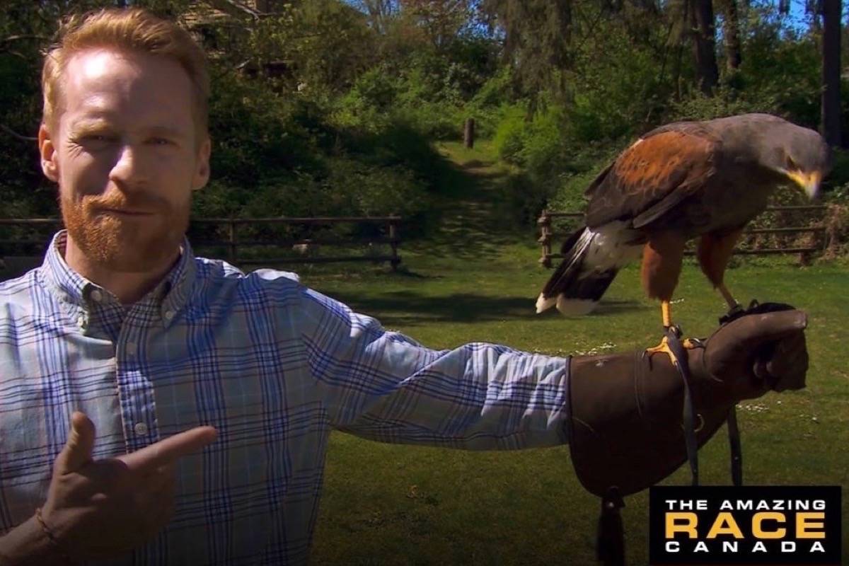 Amazing Race Canada host Jon Montgomery shows off one of the beautiful birds of prey and the gauntlet glove that each team had to use in a Cowichan Valley challenge at The Raptors Centre. (Submitted)