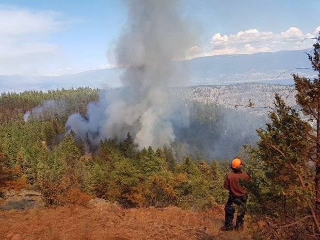 A BC Wildfire Service firefighter battles the Mount Conkle wildfire near Summerland. Image: BC Wildfire Service