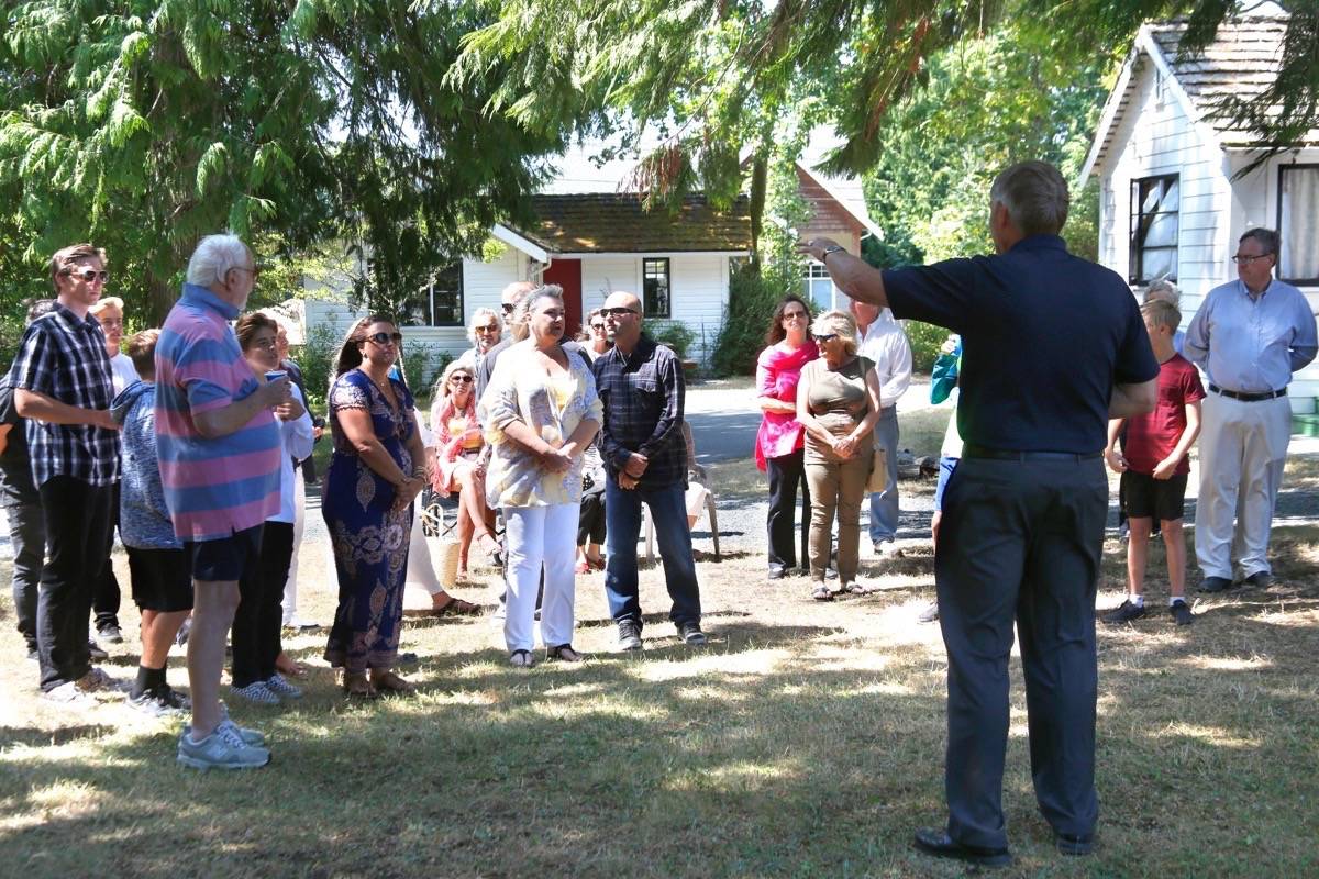 Qualicum Beach Mayor Teunis Westbroek speaks to family members of the late Elizabeth Little (former owner of St. Andrews Lodge and community activist) and others at the 80th anniversary celebration of St. Andrews Lodge on Wednesday, Aug. 1. The town will soon take ownership of the waterfront lodge property to turn it into a public park. — Adam Kveton Photo