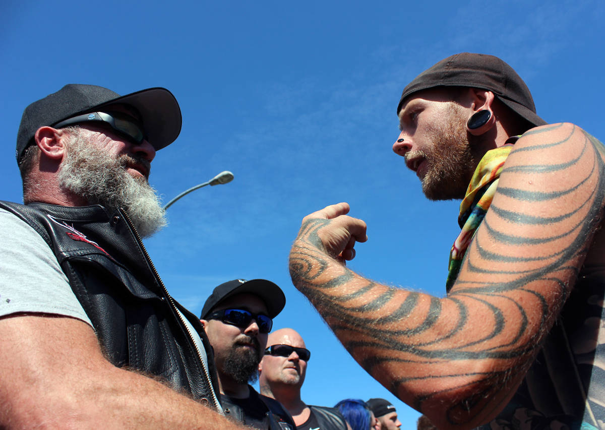 Soldiers of Odin Vancouver Island president, who refused to provide his name, meets with Jamison McGrath, a supporter of Discontent City, on Aug. 5 on Front Street during a rally that featured supporters from both sides. (Nicholas Pescod/News Bulletin)