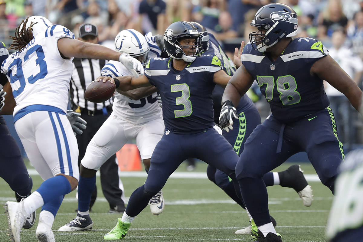 Seattle Seahawks quarterback Russell Wilson (3) passes against the Indianapolis Colts during the first half of an NFL football preseason game, Thursday, Aug. 9, 2018, in Seattle. (AP Photo/Elaine Thompson)