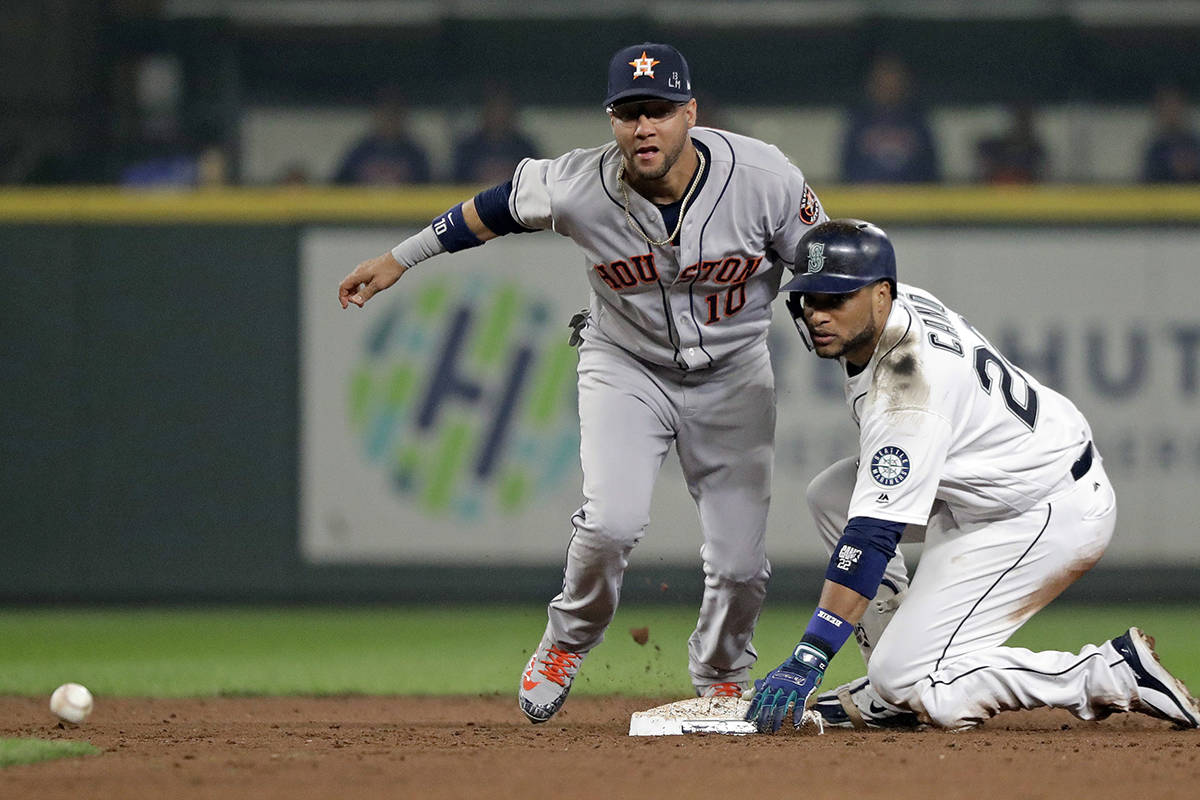 Houston Astros second baseman Yuli Gurriel, left, and Seattle Mariners’ Robinson Cano eye the ball after Cano arrived at second base on his double in the sixth inning of a baseball game, Monday, Aug. 20, 2018, in Seattle. (AP Photo/Elaine Thompson)