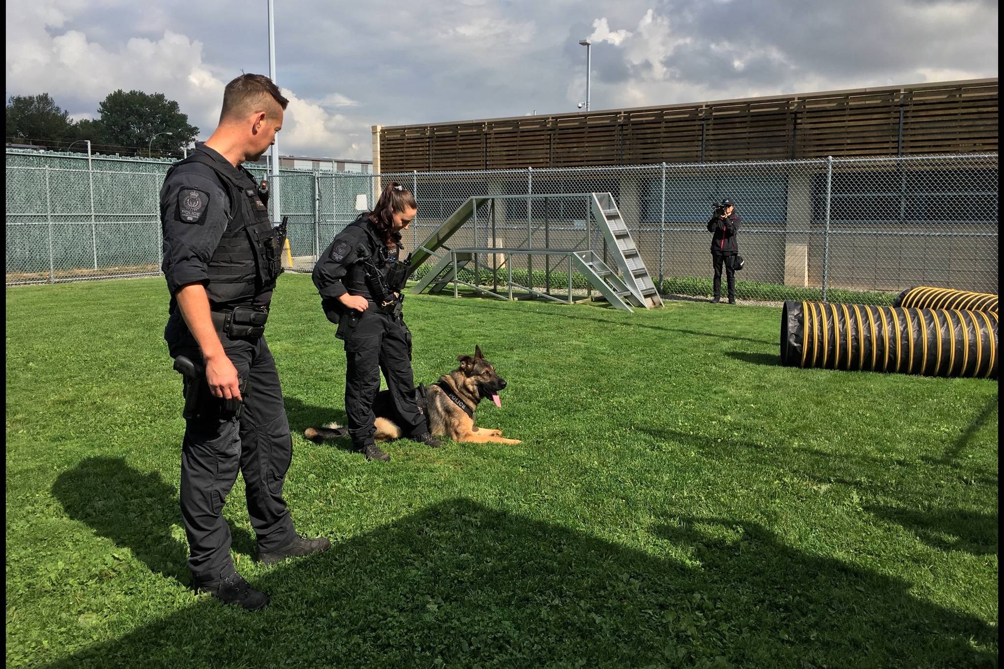 Constable Ryan Visser (left) with Constable Courtney Srigley (middle) and Hank, a German Shepherd, showcasing their skills prior to the Canadian Police Canine Association Trials from September 14 to 16 (Photo by Kieran O’Connor/Black Press Media)