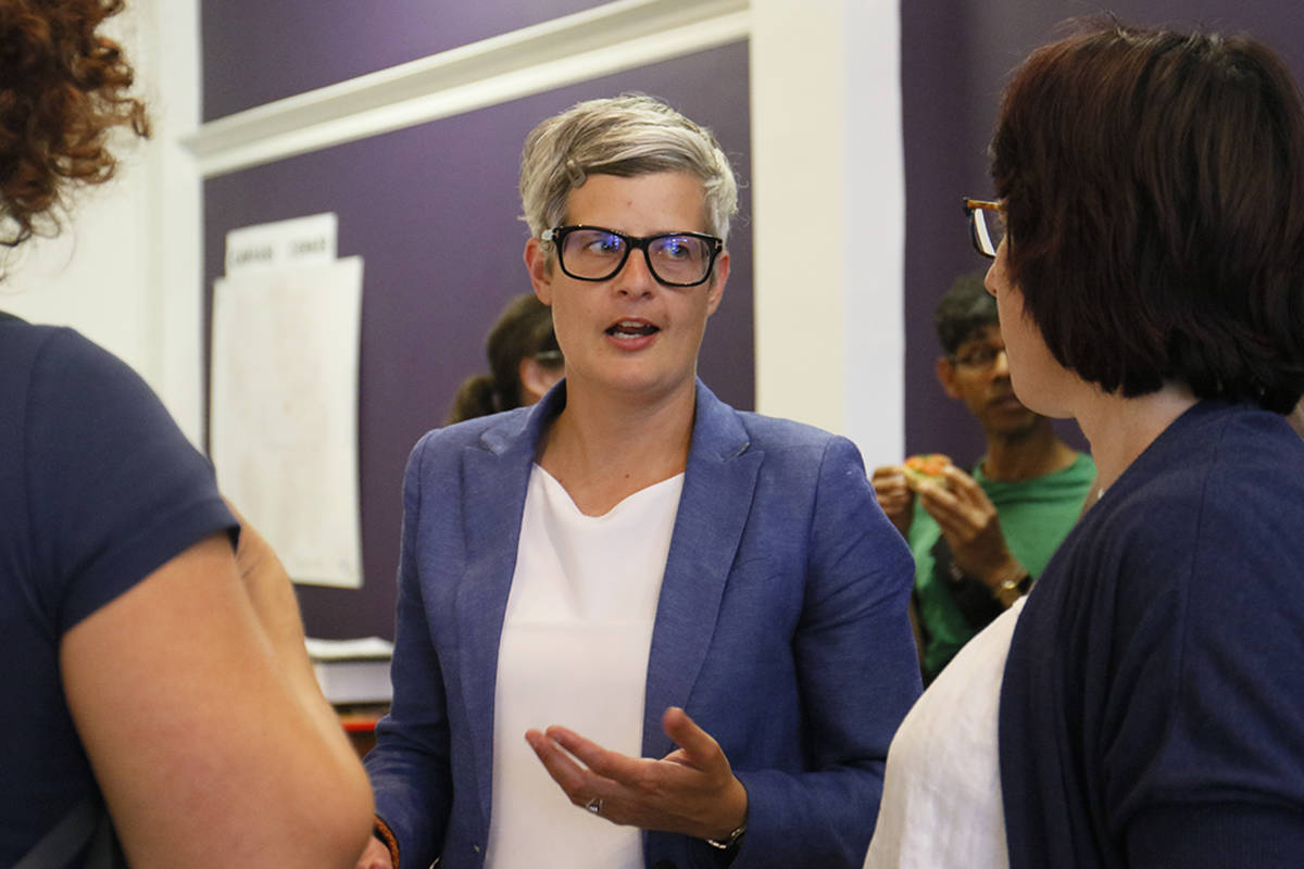 Incumbent Mayor Lisa Helps chats with Tracy James (right) and other supporters at her Fort Street campaign headquarters Aug. 7. (Kristyn Anthony/News staff)