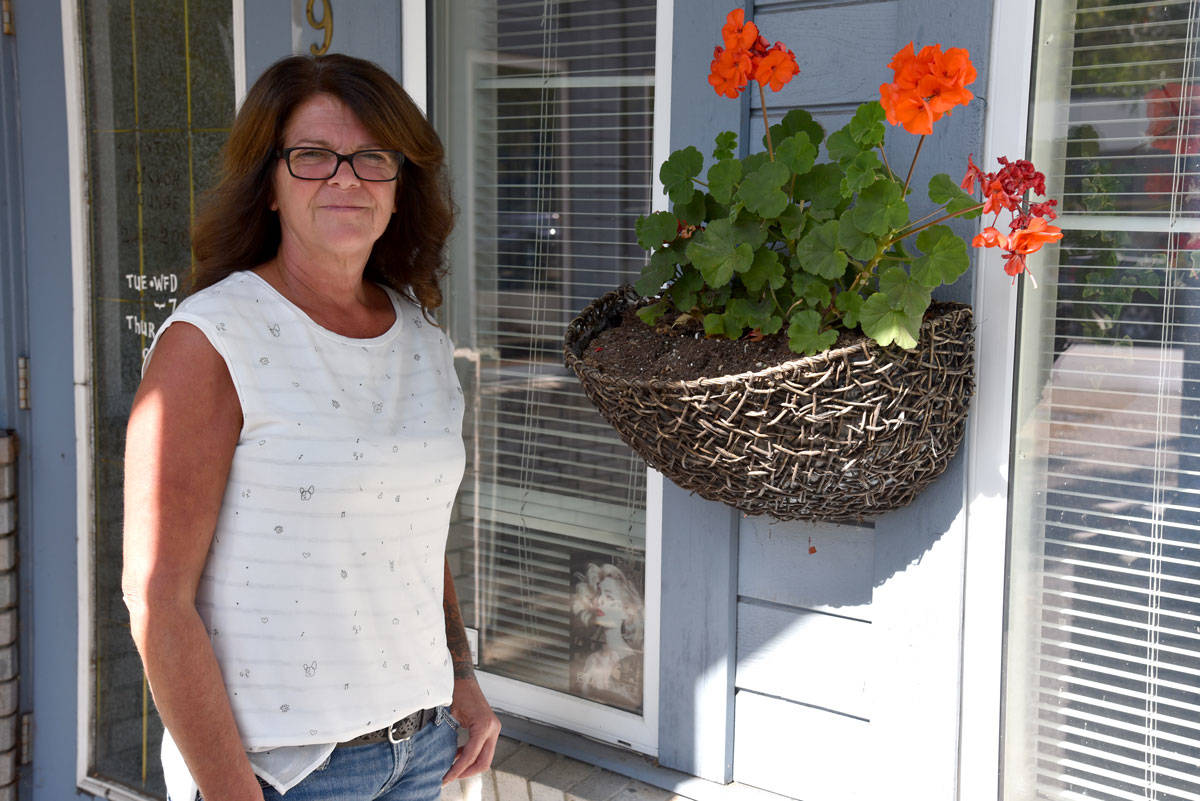 Twisted Scissor Lounge owner Cathy Lewis stands next to the wall planter where she discovered a syringe buried in the soil. (Mike Gregory Photo)