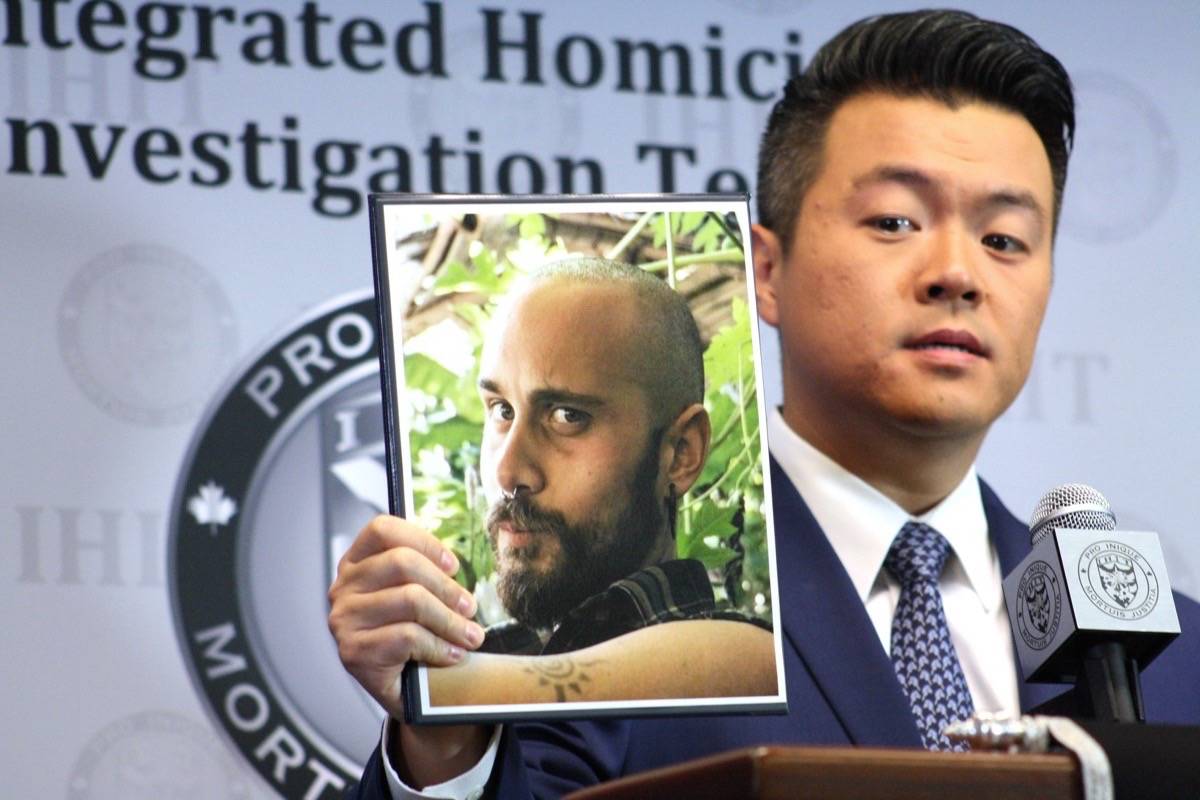IHIT Cpl. Frank Jang holds up a photo of Sean McKenzie, 27, who is facing a first-degree murder charge in connection to the death of Belgian tourist Amelie Sakkalis, 28, near Boston Bar on Aug. 22. (Katya Slepian/Black Press Media)