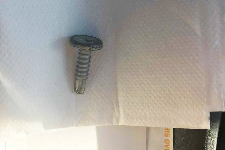 One of the screws pulled from a truck tire after passing through the Island Highway and Ocean Boulevard intersection in Colwood Thursday evening. (Melissa Mitchell/Black Press)