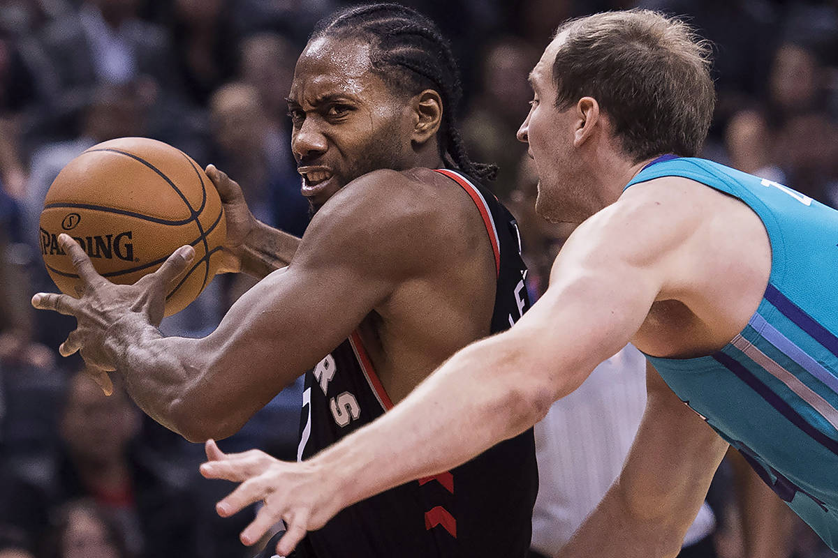 Toronto Raptors forward Kawhi Leonard (2) drives past Charlotte Hornets forward Cody Zeller (40) during second half NBA basketball action in Toronto on Monday, October 22, 2018. THE CANADIAN PRESS/Nathan Denette
