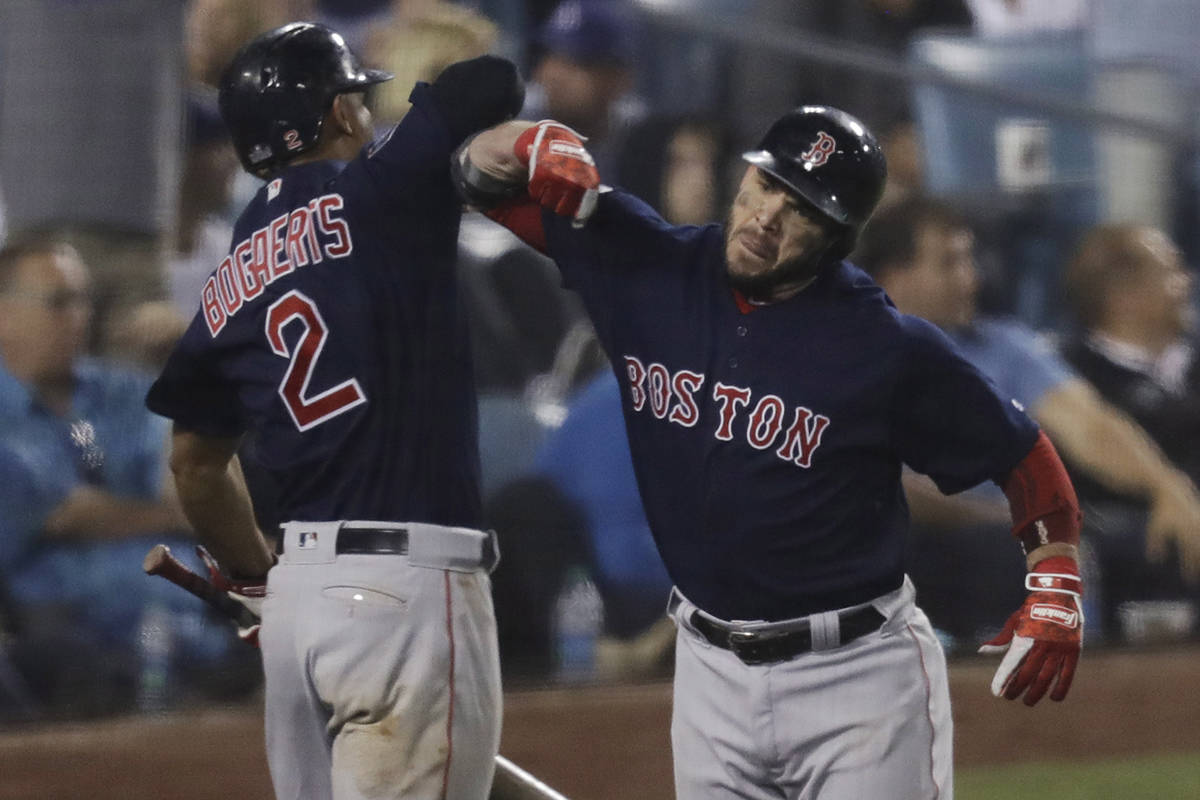 Boston Red Sox’s Steve Pearce celebrates his solo home run to tie the game Xander Bogaerts with during the eighth inning in Game 4 of the World Series baseball game against the Los Angeles Dodgers on Saturday, Oct. 27, 2018, in Los Angeles. (AP Photo/Elise Amendola)