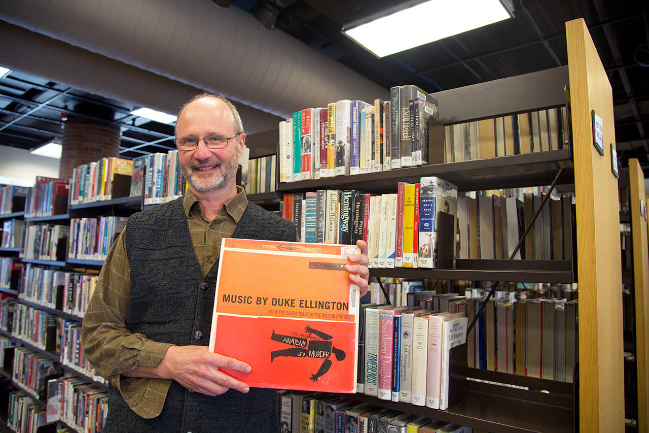 Carl Cavanagh holds a copy of an LP version of the “Anatomy of a Murder” soundtrack, which was recently returned to the library – more than 20 years have the library stopped lending records (Nicole Crescenzi/News Staff)