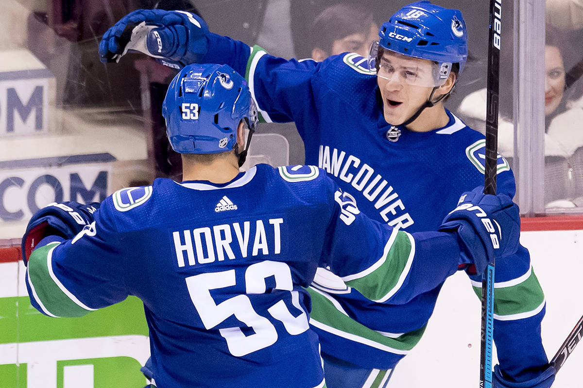 Vancouver Canucks right wing Jake Virtanen (18) celebrates his goal with teammate Bo Horvat (53) during second period NHL hockey action against the Minnesota Wild in Vancouver, Monday, Oct. 29, 2018. THE CANADIAN PRESS/Jonathan Hayward