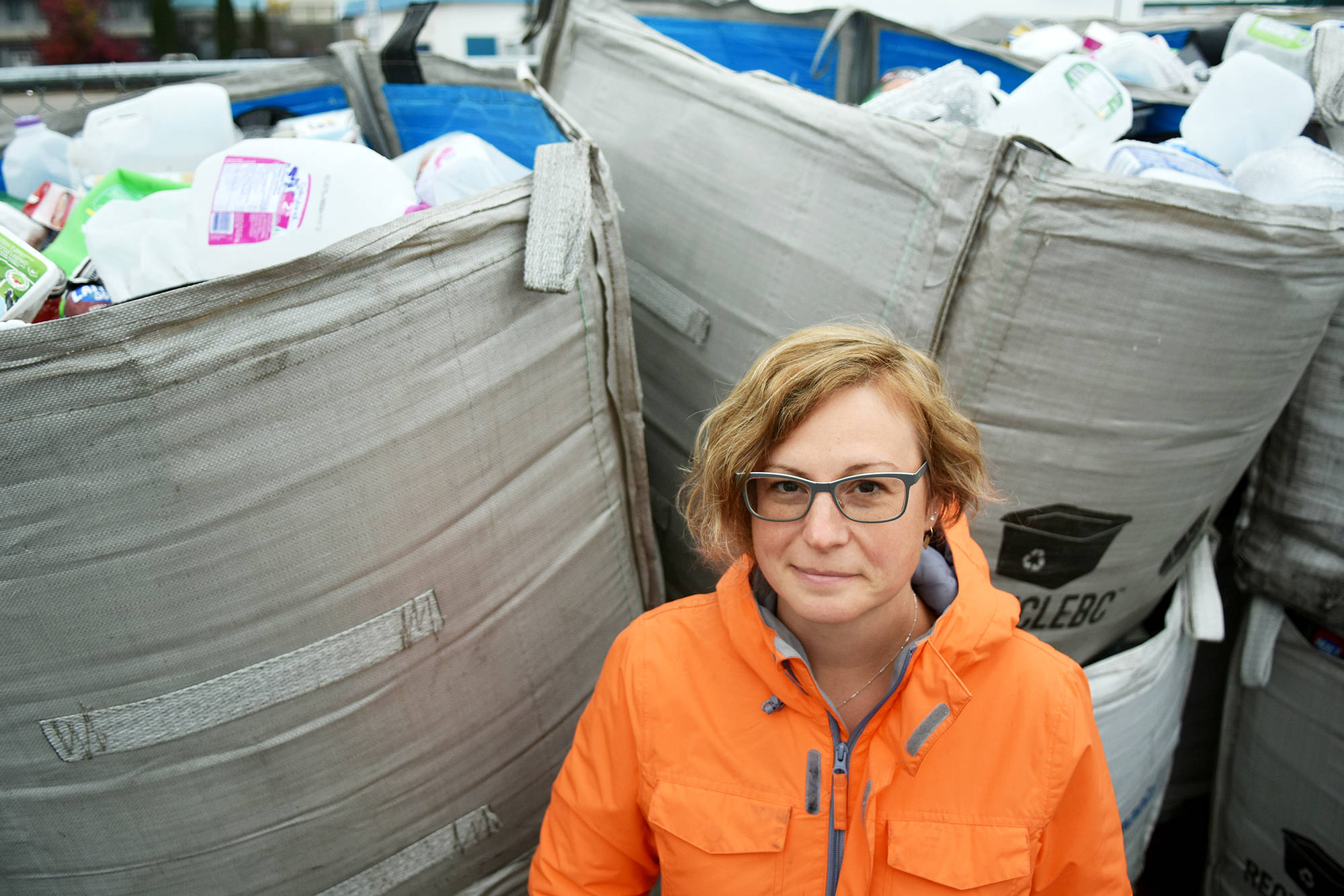 Chélie Elsom stands in front of bags of recyclable plastic in Salmon Arm, plastics that, in B.C., will be remanufactured into new items. Elsom has created a petition she hopes will be presented in the House of Common, asking for a national strategy that will prohibit the use of single-use plastic. (Lachlan Labere/Salmon Arm Observer)