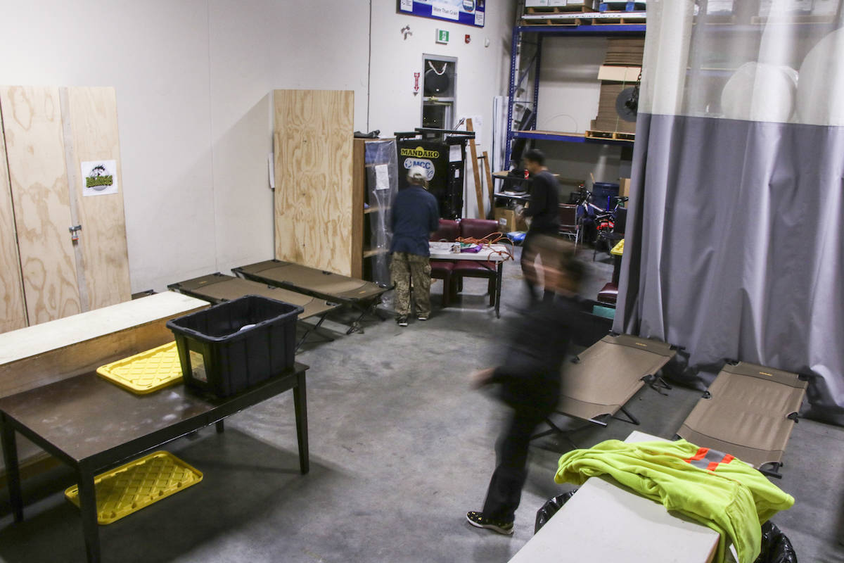 Staff bustle through the the 5 and 2 Ministries-operated winter shelter at the Mennonite Central Committee space on Gladys Avenue, converting the small space from a warehouse to a temporary winter shelter each night, disassembling the shelter without a trace each morning. Dustin Godfrey/Abbotsford News
