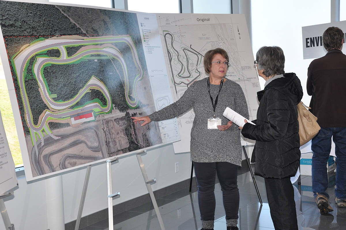 Sarah Bonar, left, answers questions about environmental concerns at the Motorsport Circuit’s open house on Saturday. (Warren Goulding/Citizen)