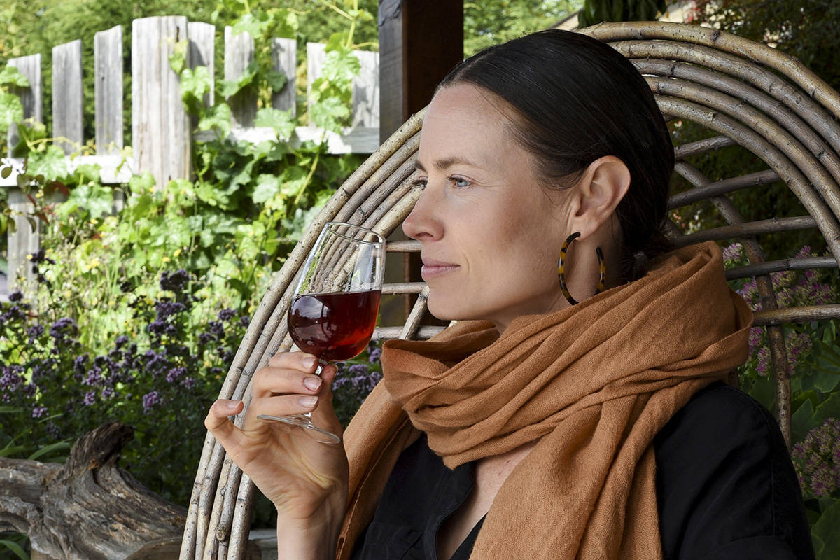 Lia Crowe enjoys a glass of Harvest Melomel, Mixed Berry Melomel Mead, at the Tugwell Creek Honey Farm and Meadery. Don Denton photography