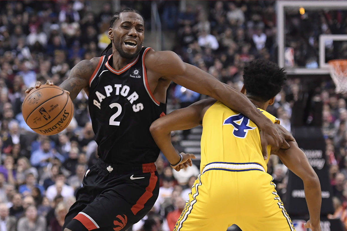 Toronto Raptors forward Kawhi Leonard (2) moves around Golden State Warriors guard Quinn Cook (4) during first half NBA basketball action in Toronto on Thursday Nov. 29, 2018. THE CANADIAN PRESS/Nathan Denette
