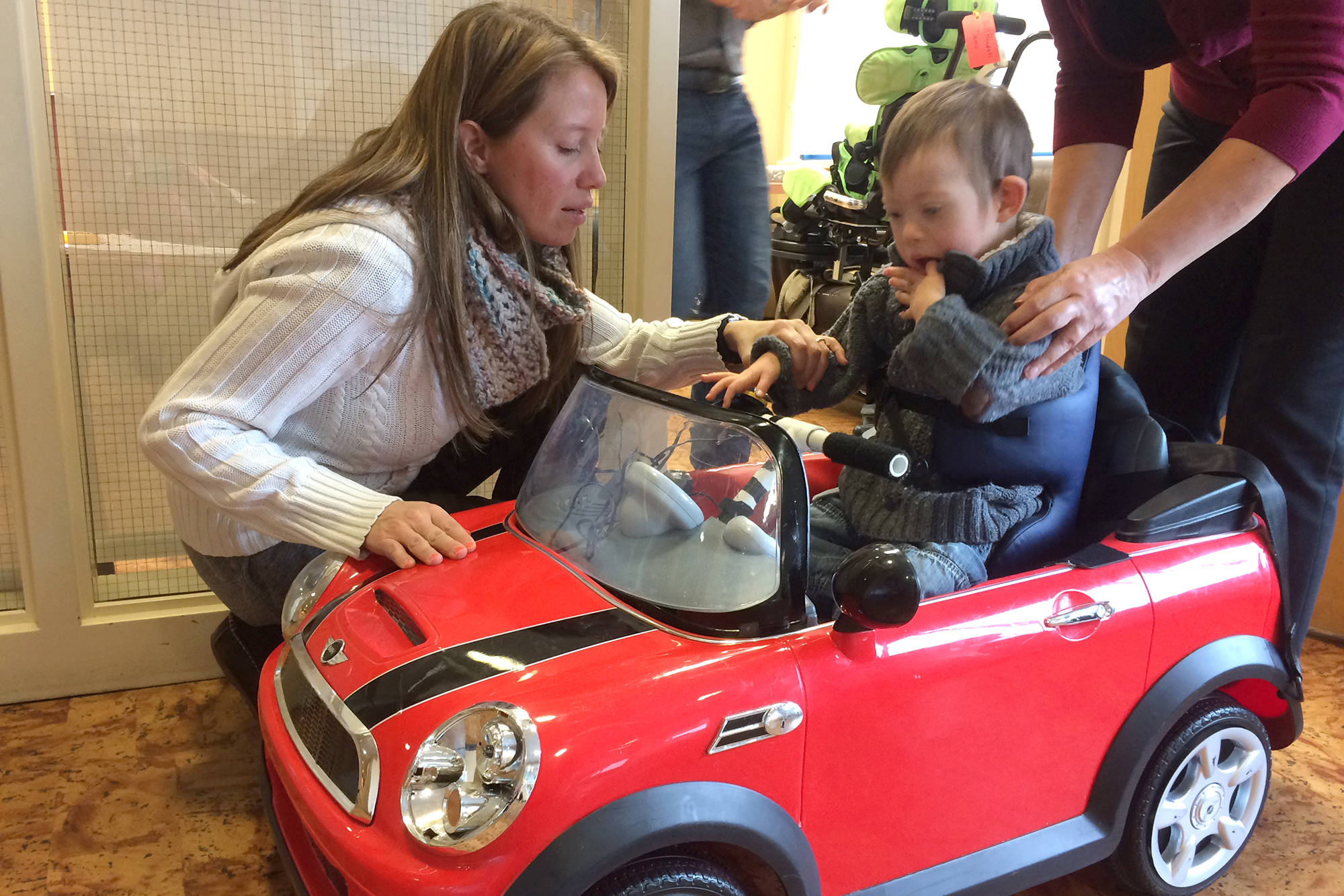 Shuswap Children’s Association physiotherapist is Estera Hazlewood is teaching four-year-old Oli Brooks how to push a button on an adaptive car. The association is unable to provideOli with the number of hours he requires for his complex needs. (Zev Tiefenbach photo)
