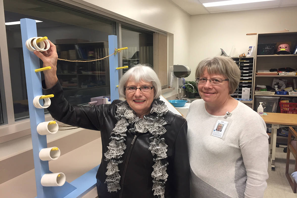 Rita Wiens and her daughter Sharon Campbell, an occupational therapist with Interior Health, standing next to a physiotherapy exercise device at Kelowna General Hospital. Photo: Barry Gerding/Black Press