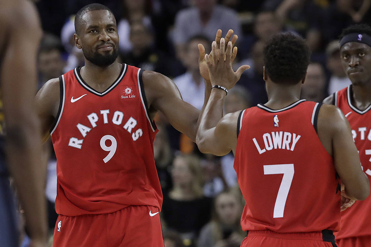 Toronto Raptors forward Serge Ibaka (9) celebrates with guard Kyle Lowry (7) during the second half of an NBA basketball game against the Golden State Warriors in Oakland, Calif., Wednesday, Dec. 12, 2018. (AP Photo/Jeff Chiu)