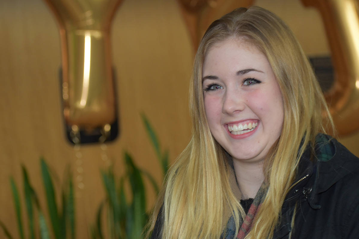 Briar Mayoh is all smiles as she arrives at the Victoria International Airport Wednesday as the 2-millionth passenger to travel through its doors. (Kristyn Anthony/News staff)