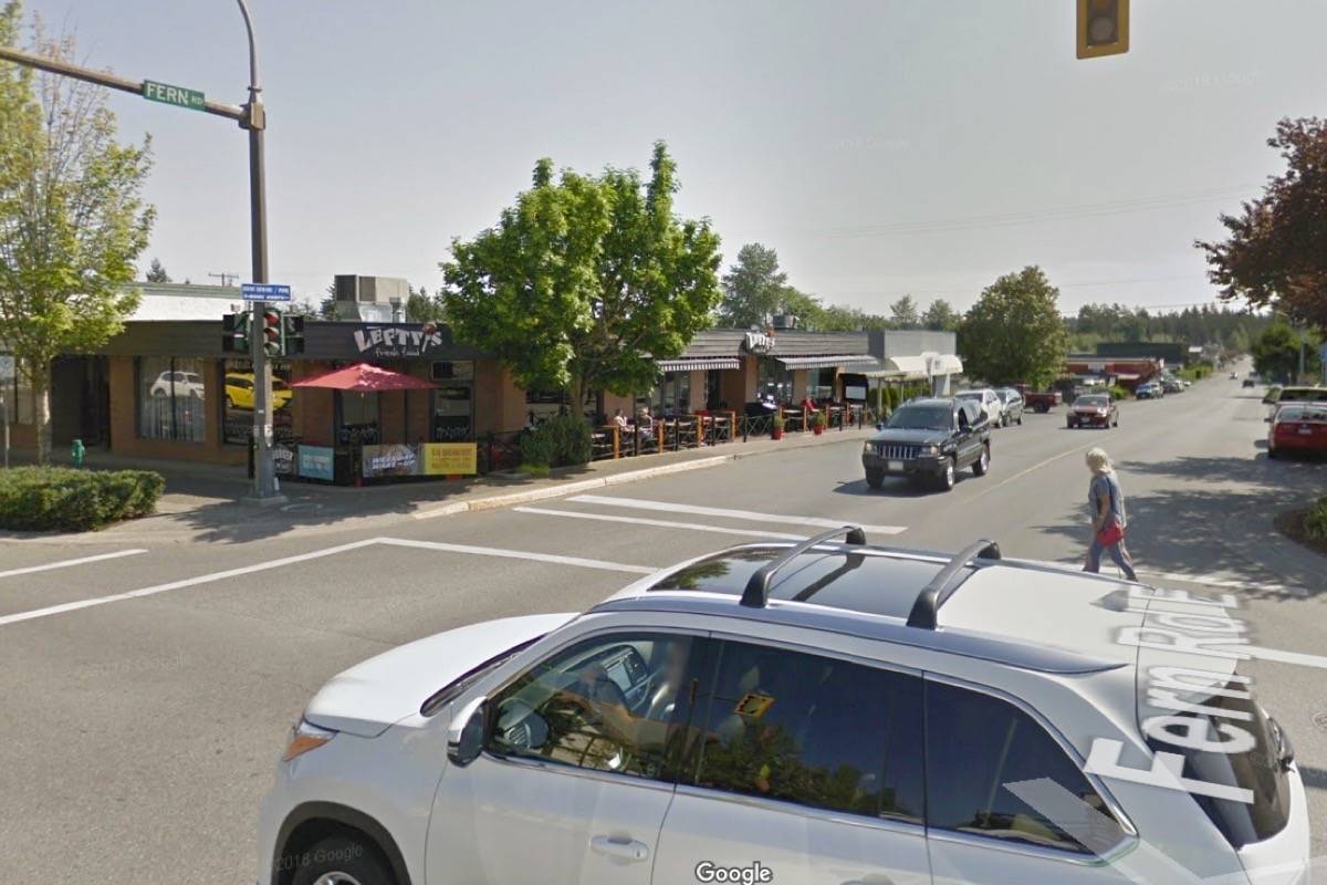 A pedestrian makes their way across Fern Road at Memorial Avenue in Qualicum Beach. The town’s council has just agreed to have staff look into extending the signalized cross time, as some citizens have spoken out saying it’s not long enough. — Google Maps image