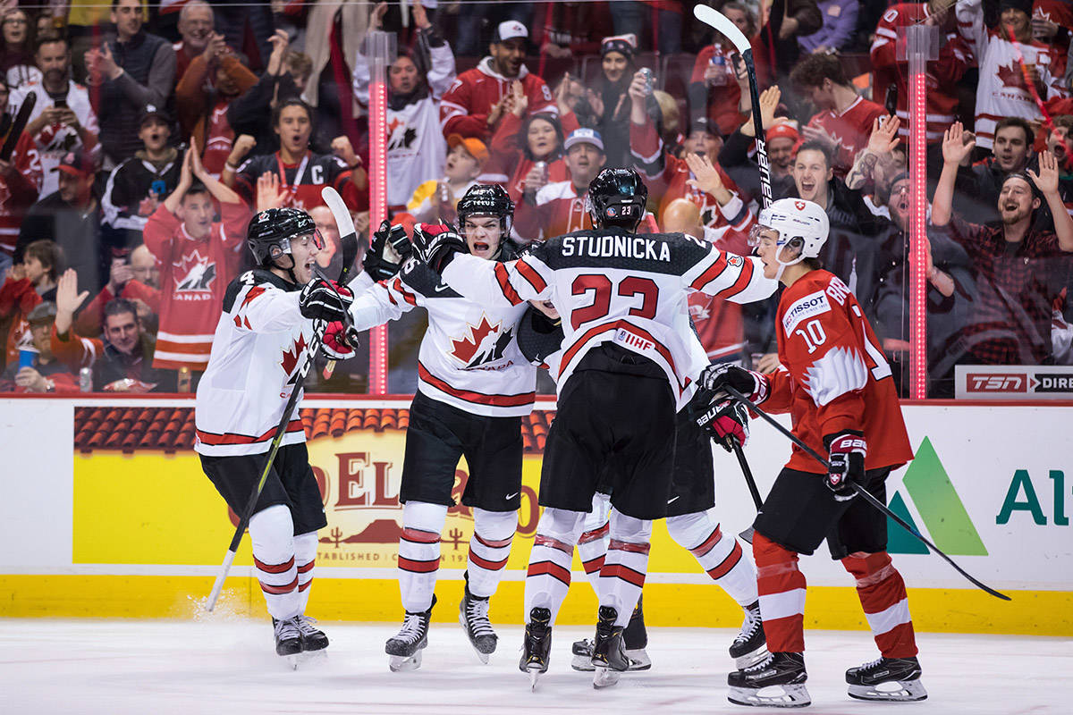 Canada’s Jared McIsaac, from left to right, Shane Bowers, MacKenzie Entwistle, back right, and Jack Studnicka celebrate Entwistle’s goal as Switzerland’s Yannick Bruschweiler (10) skates to the bench during second period IIHF world junior hockey championship action in Vancouver, on Thursday December 27, 2018. THE CANADIAN PRESS/Darryl Dyck