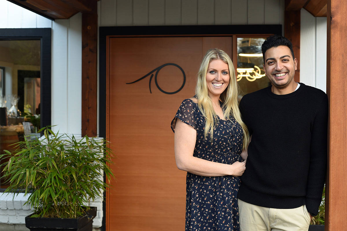 Tasem and Elyse Ramaden stand outside the main entrance to their winery, Deep Cove Winery. Don Denton photography