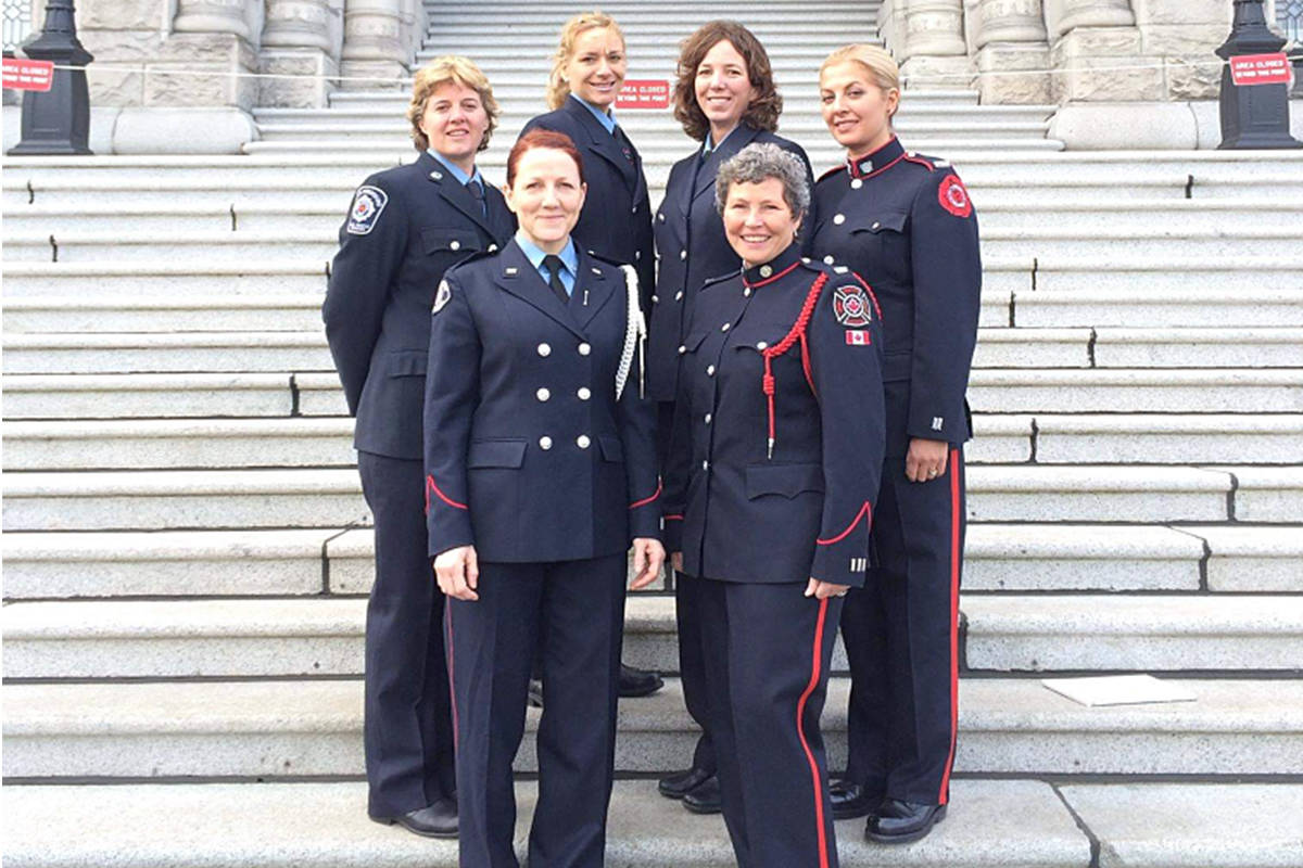 Firefighters Krista Harris (far left) and wife Cathy Van-Martin (back row, second from right) of Abbotsford rescued a mom and two kids who were unconscious in their vehicle on Boxing Day due to suspected carbon-monoxide poisoning. The pair are shown here with a contingent of firefighters to lobby at the legislature in Victoria.