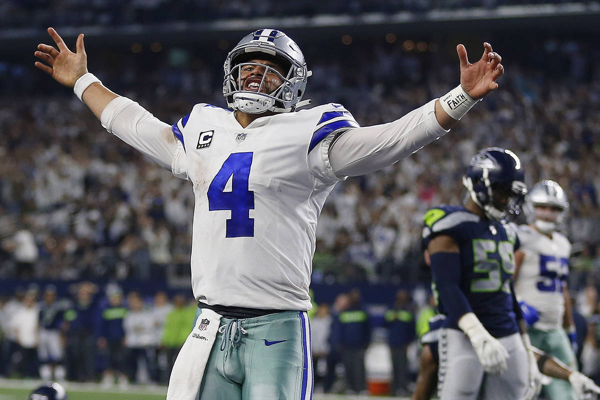 Dallas Cowboys quarterback Dak Prescott (4) celebrates his first down near the goal line against the Seattle Seahawks during the second half of the NFC wild-card NFL football game in Arlington, Texas, Saturday, Jan. 5, 2019. (AP Photo/Ron Jenkins)