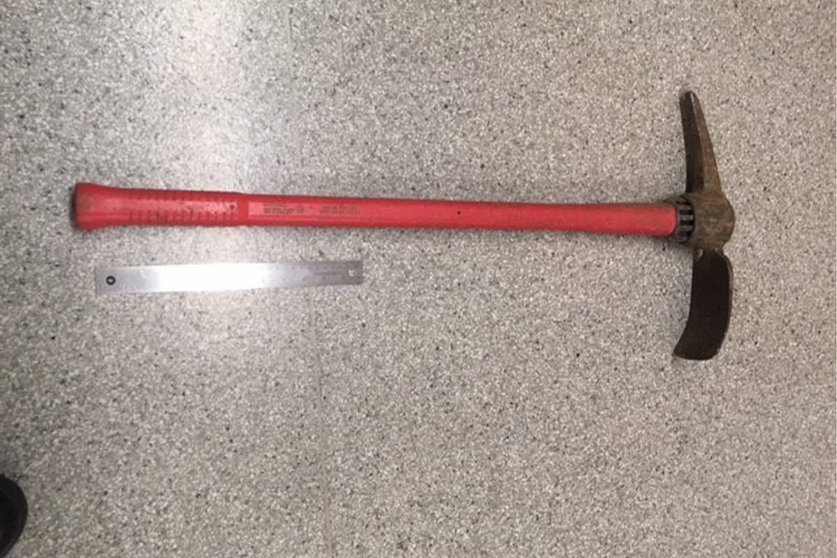 A man carried a pickaxe down Oak Bay Avenue before being apprehended by police on Jan. 8. (Courtesy Oak Bay Police)
