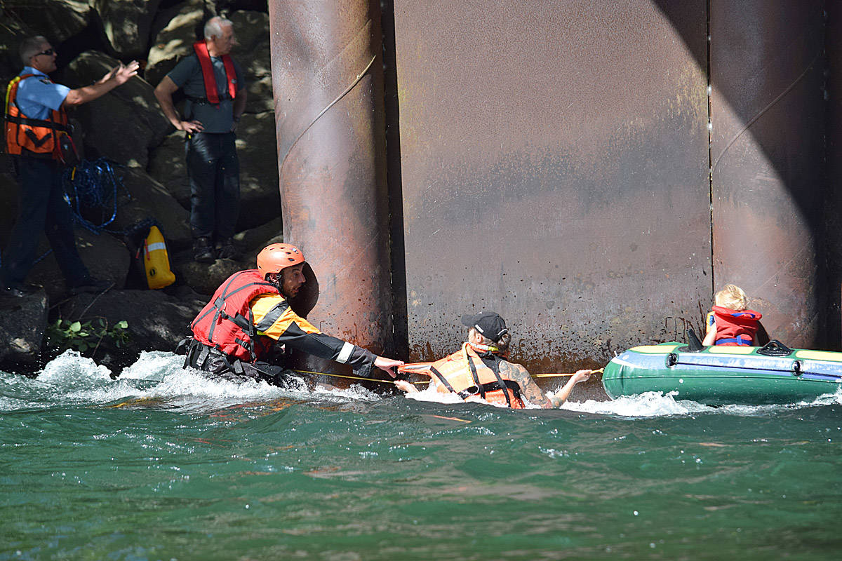 Members of Campbell River Search and Rescue (CRSAR) help a small child whose raft was caught on the supports of a bridge on July 10, 2018. CRSAR reports that it responded to 54 calls last year. Photo by David Gordon Koch/Campbell River Mirror