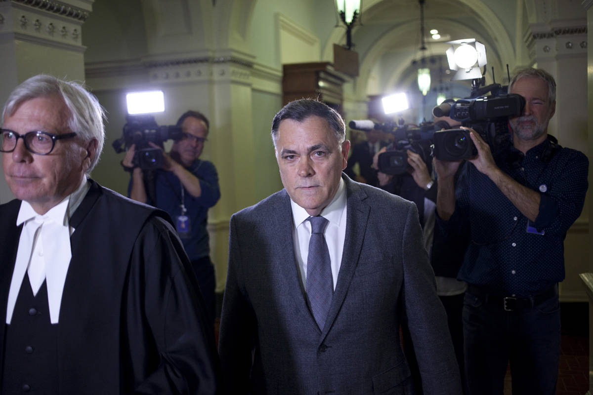 Former B.C. Liberal MLA Darryl Plecas is escorted from the legislative chamber by Clerk of the House Craig James (left) after his surprise election as speaker, Sept. 8, 2017. James and Sergeant-at-Arms Gary Lenz were suddenly suspended from their duties last week. (Chad Hipolito/The Canadian Press/Pool)