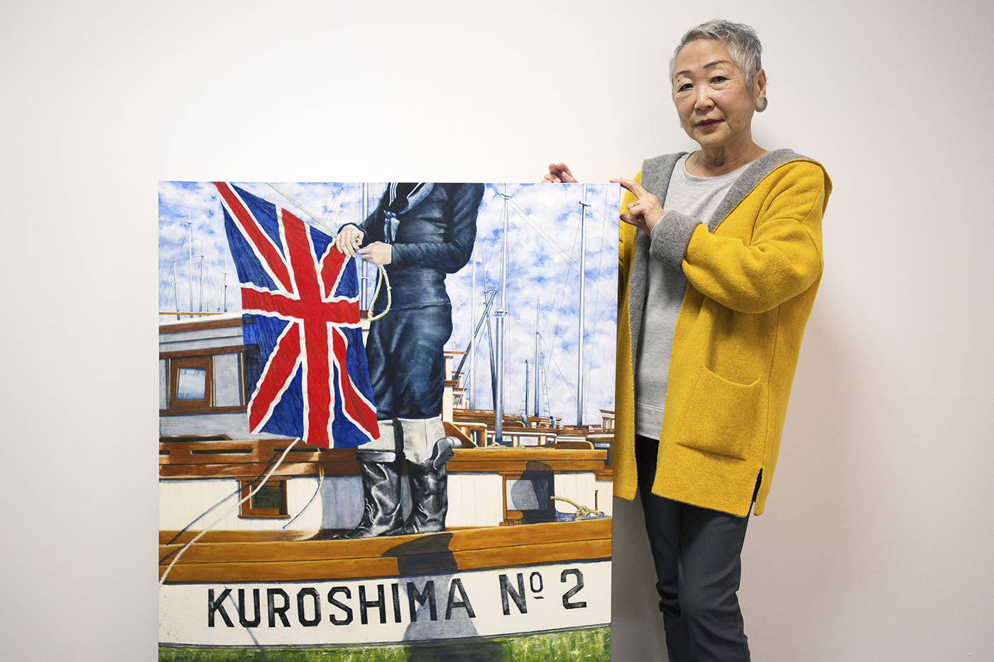 Japanese-Canadian artist Marlene Howell stands with her piece “Under new ownership” at The Lost Fleet exhibit, opening Saturday at the Maritime Museum of BC. (Keri Coles/News staff)