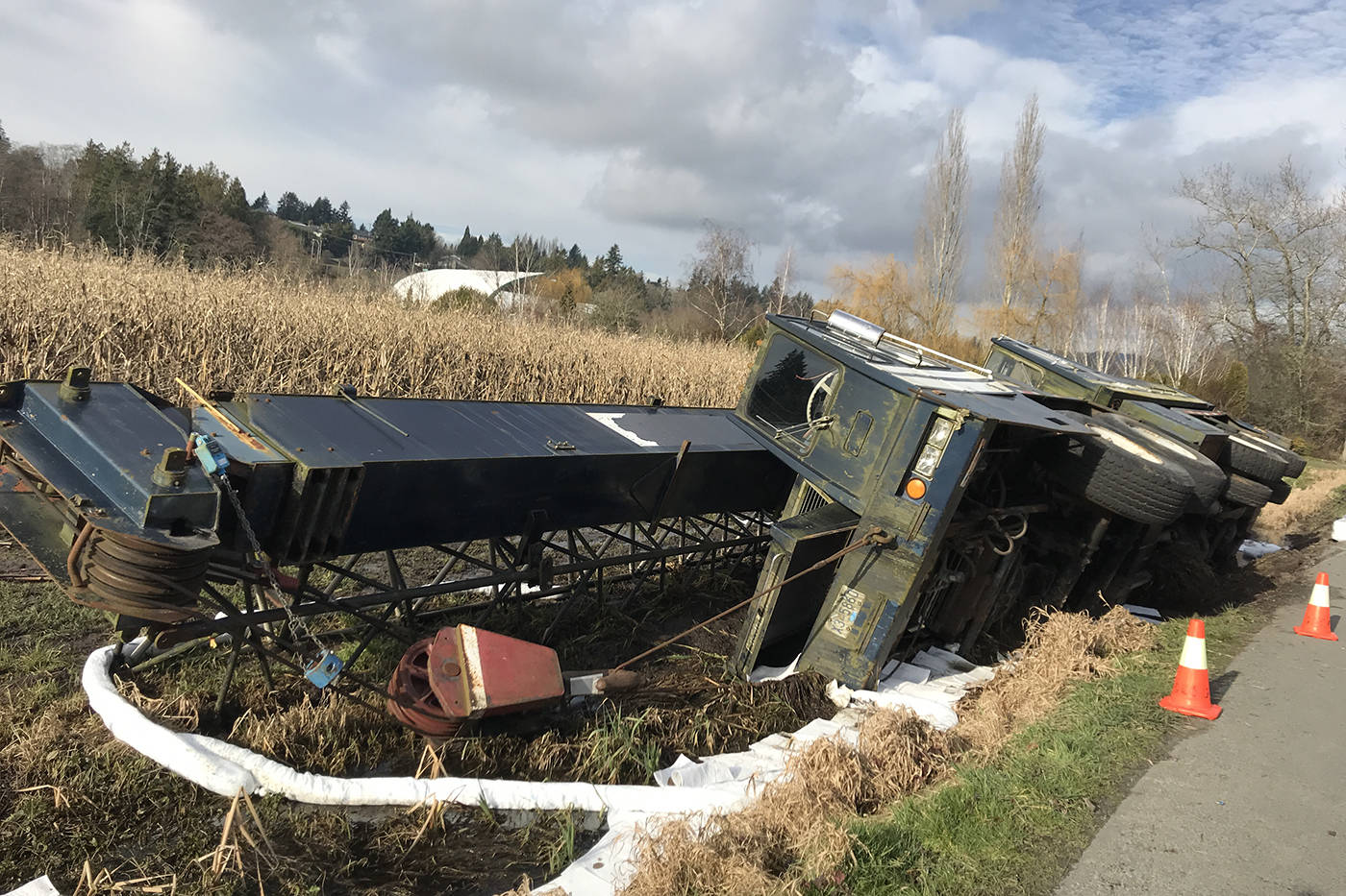 A turned over truck on Lochside Drive in Central Saanich seeps oil into the nearby ground. (Keri Coles/News staff)
