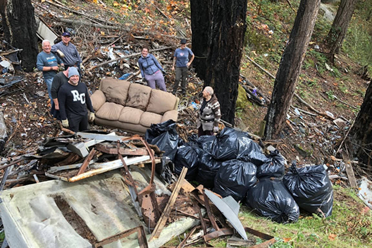 Volunteers begin to cleanup large amounts of garbage scattered on the slopes of Little Mountain. Rotary Club of Parksville AM members are organizing more cleanup efforts and helicoters to haul garbage away this spring. - Photo courtesy Rotary Club of Parksville AM