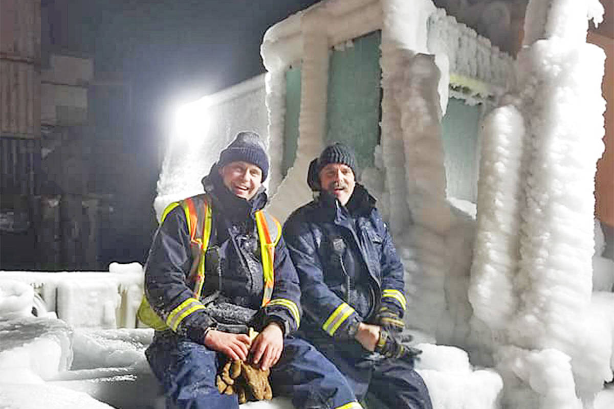 BC Ferries deckhands Travis Young (left) and Todd Nickless sit on the back an ice-covered semi-truck aboard the Nimpkish en route from Bella Bella to Bella Coola on Saturday evening. (Photo submitted)