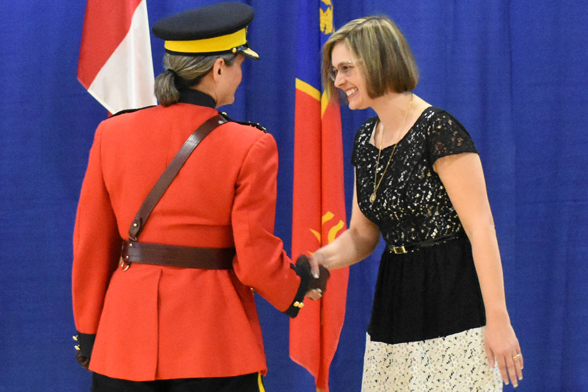 Deputy Commissioner Brenda Butterworth-Carr shakes Angela Feltrin’s hand. (Samantha Anderson)